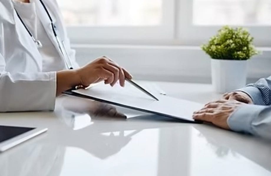 Doctor discussing paperwork with patient.