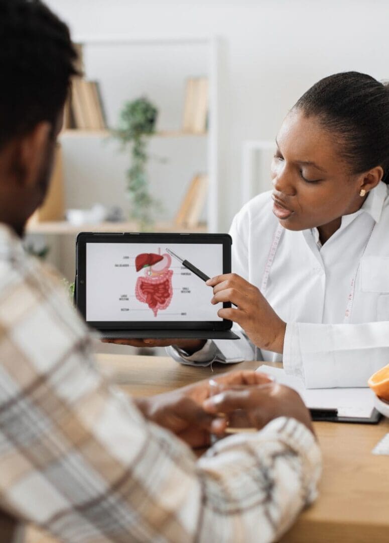 Doctor explaining digestive system on tablet.